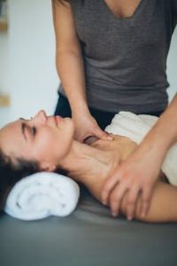 Woman receiving a calming spa massage, emphasizing relaxation and wellness.